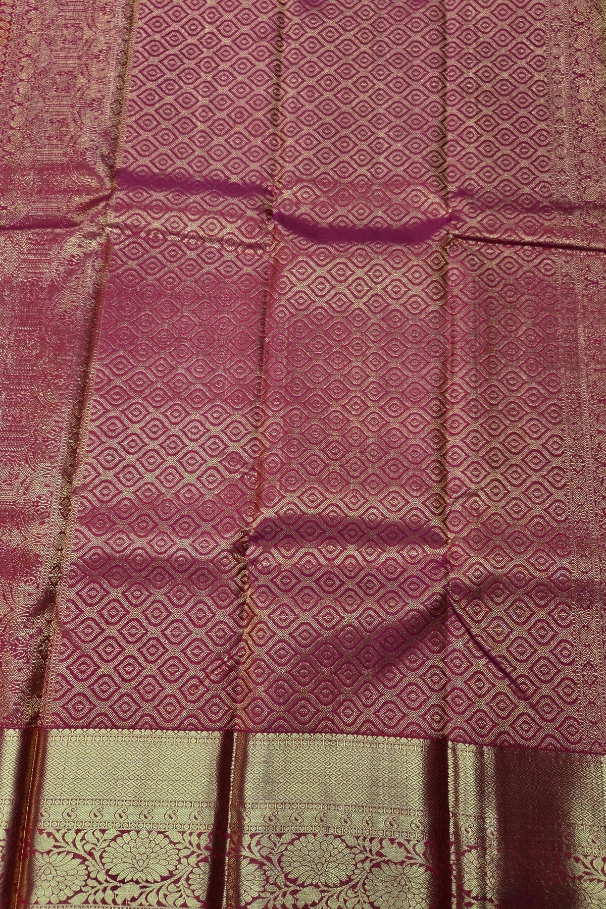 Textured fabric with a patterned design in shades of pink and beige.