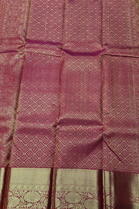 Textured fabric with a patterned design in shades of pink and beige.
