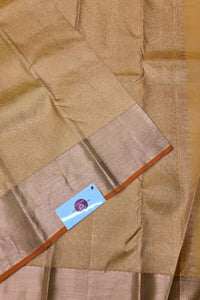 Close-up of a brown fabric with a visible brand label on a wooden surface