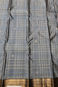 Blue checkered fabric with gold patterns and a decorative border.