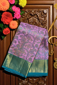 Purple and green saree with floral decorations on a wooden door