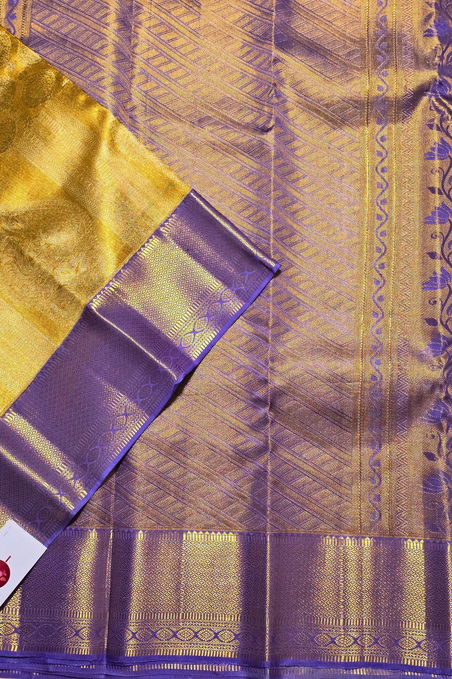 Close-up of a yellow and purple fabric with intricate patterns