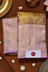 Purple and gold patterned fabric with a brand label on a brown surface.