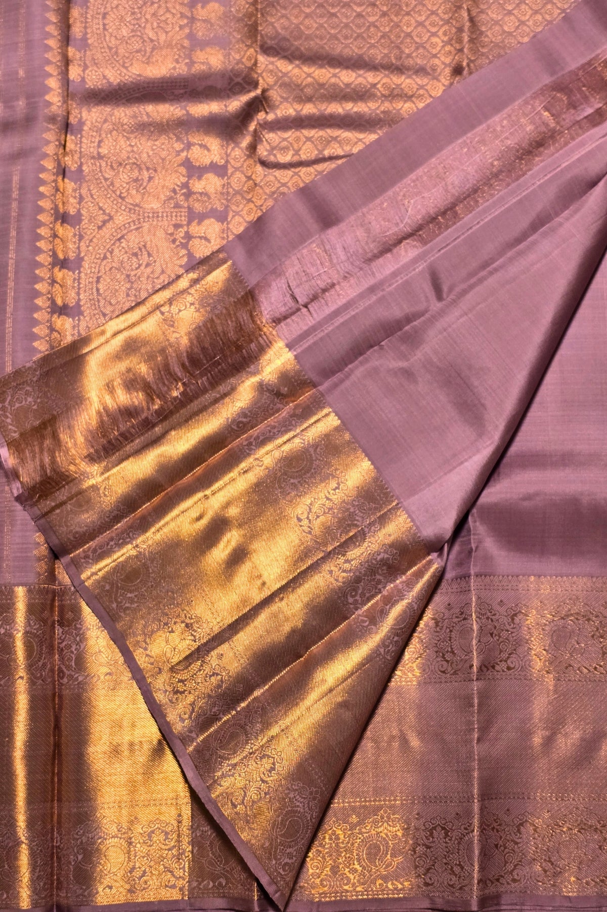 Purple saree with gold border and patterns