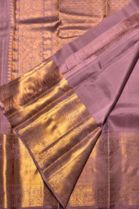 Purple saree with gold border and patterns