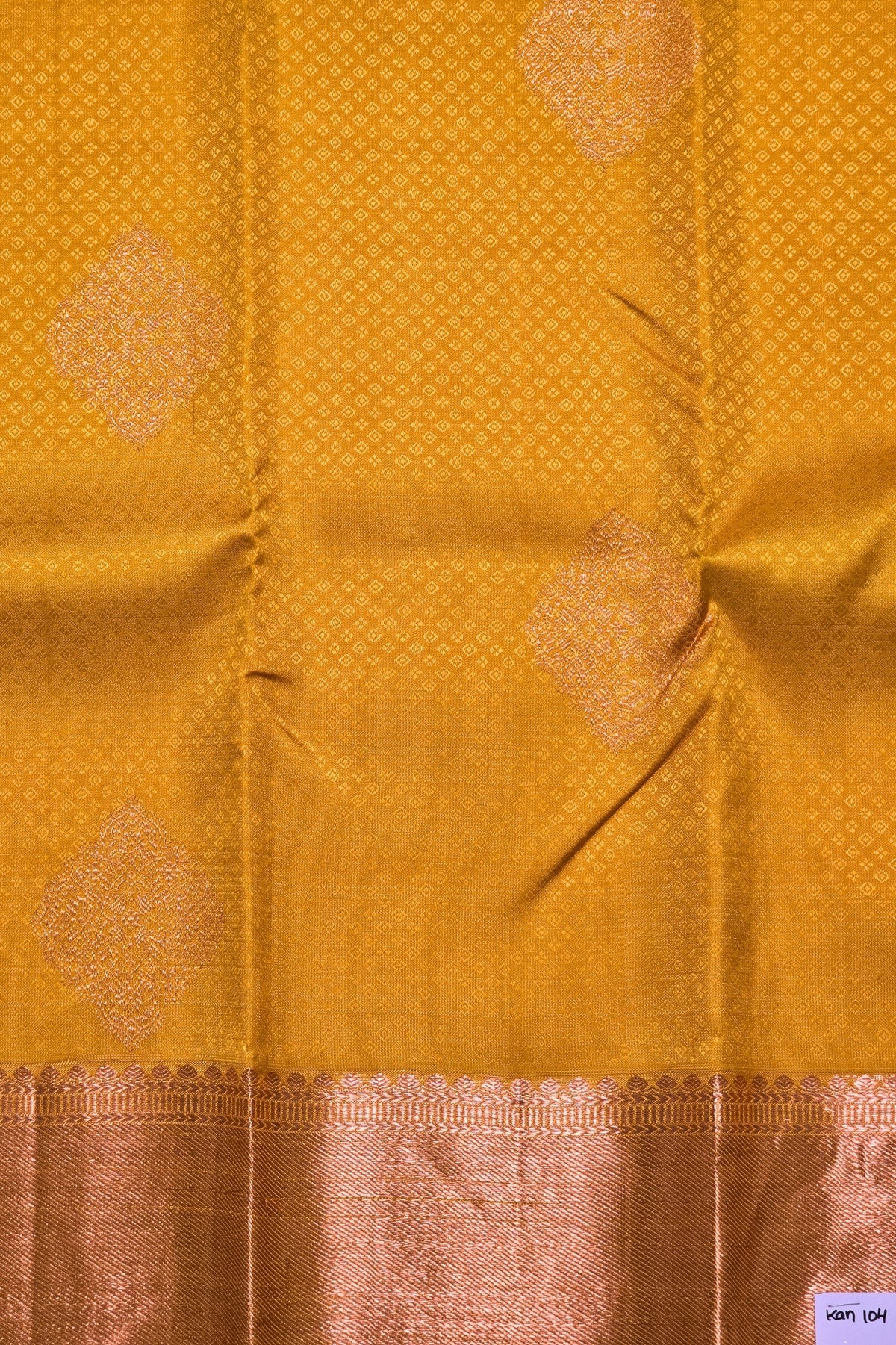 Mustard yellow fabric with intricate patterns