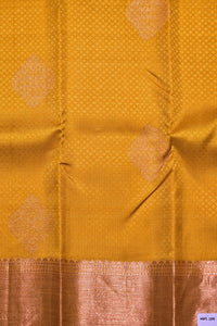 Mustard yellow fabric with intricate patterns