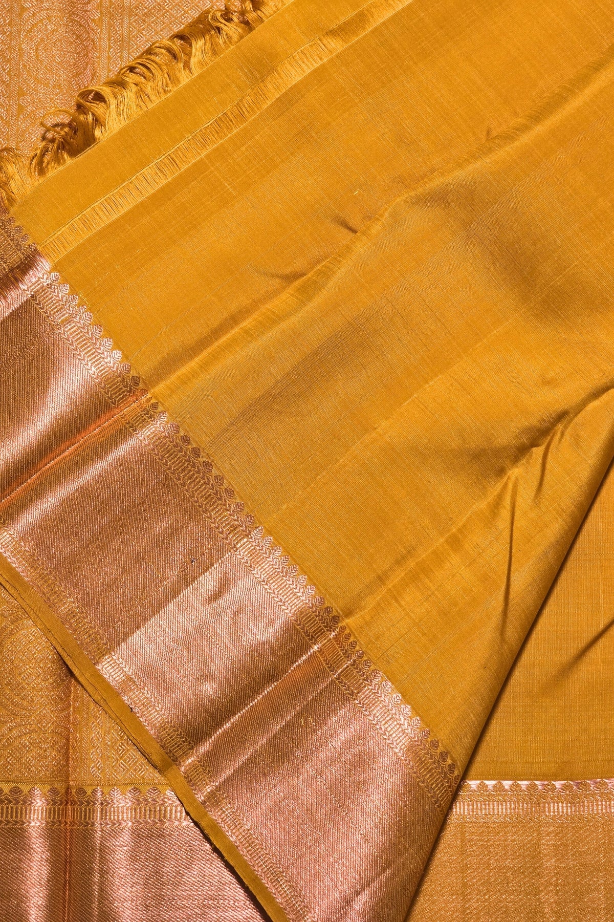 Close-up of a yellow saree with a border