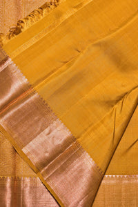 Close-up of a yellow saree with a border