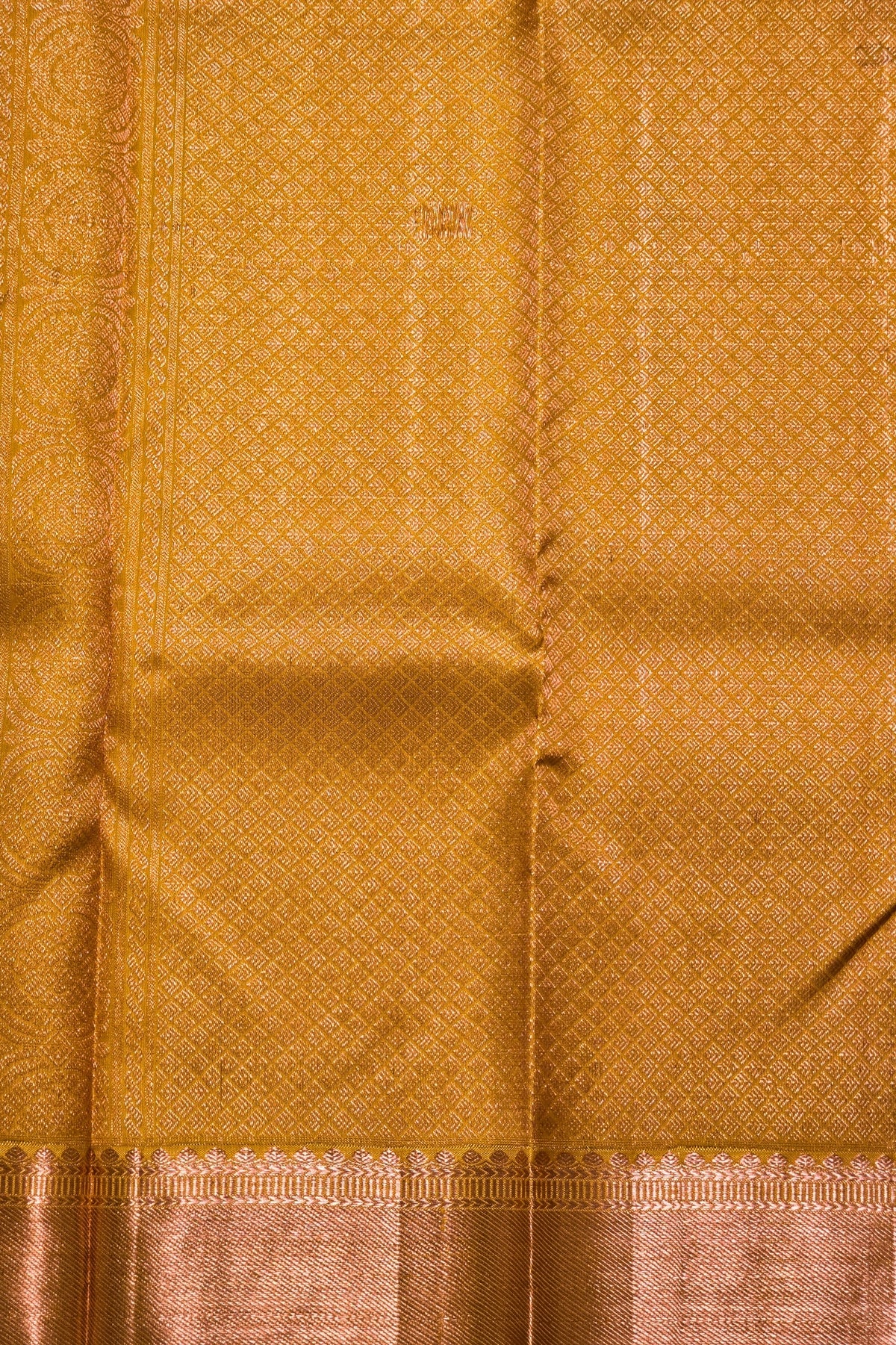 Close-up of a mustard yellow fabric with a subtle pattern