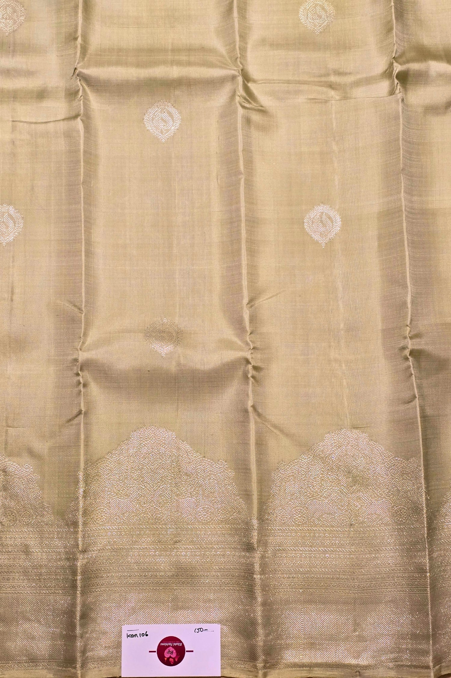Beige fabric with subtle patterns and a visible brand label in the corner.