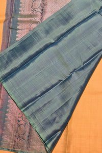 Green fabric with a subtle pattern on a wooden surface