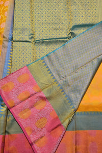 Close-up of a colorful fabric with patterns and a pink section with orange dots.