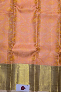 Silk fabric with a patterned design on a peach and green background
