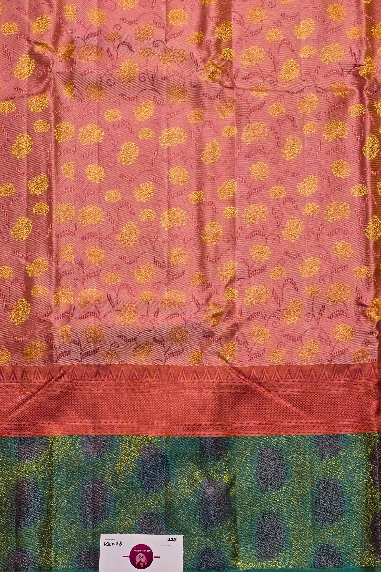 Fabric with pink background and yellow floral pattern, green border