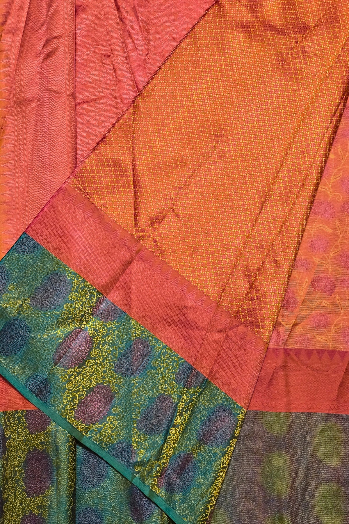Close-up of a colorful fabric with geometric patterns in red, orange, green, and purple.