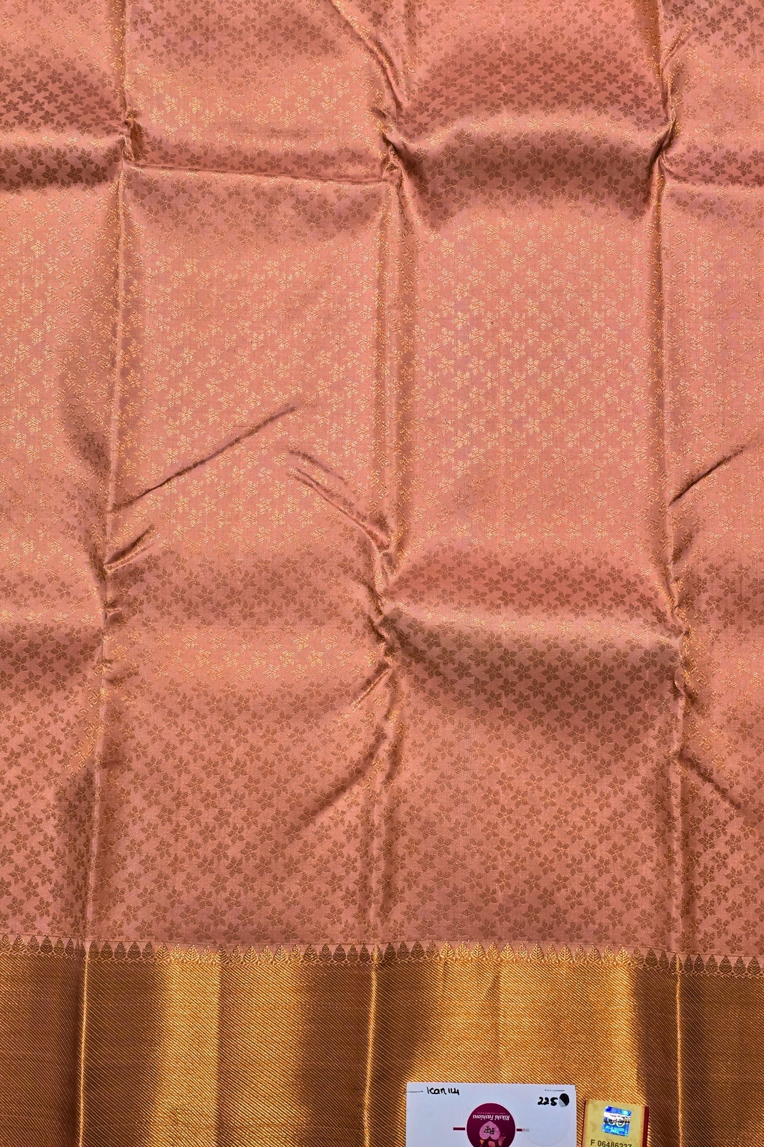 Brown fabric with a subtle pattern and gold border, featuring a brand label.