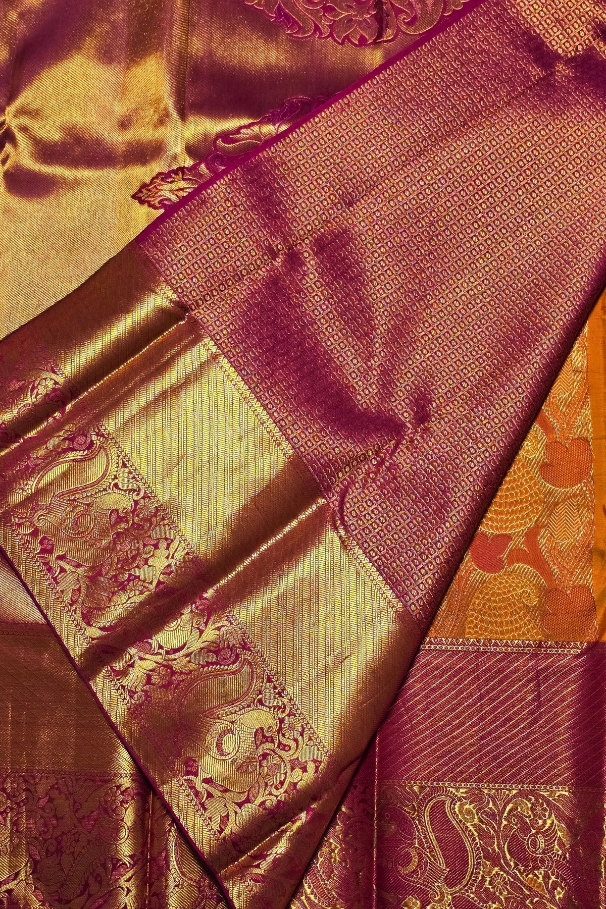 Close-up of a fabric with gold and purple patterns