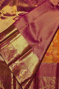 Close-up of a fabric with gold and purple patterns