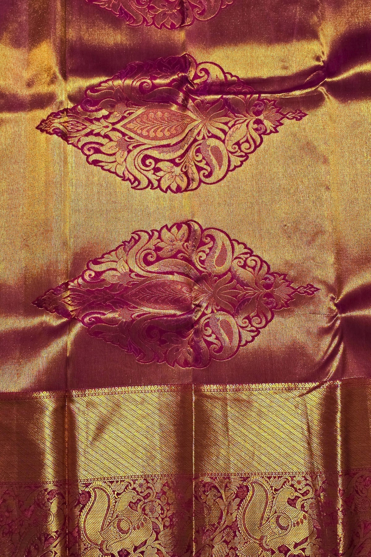 Gold fabric with intricate purple patterns