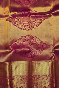 Gold fabric with intricate purple patterns