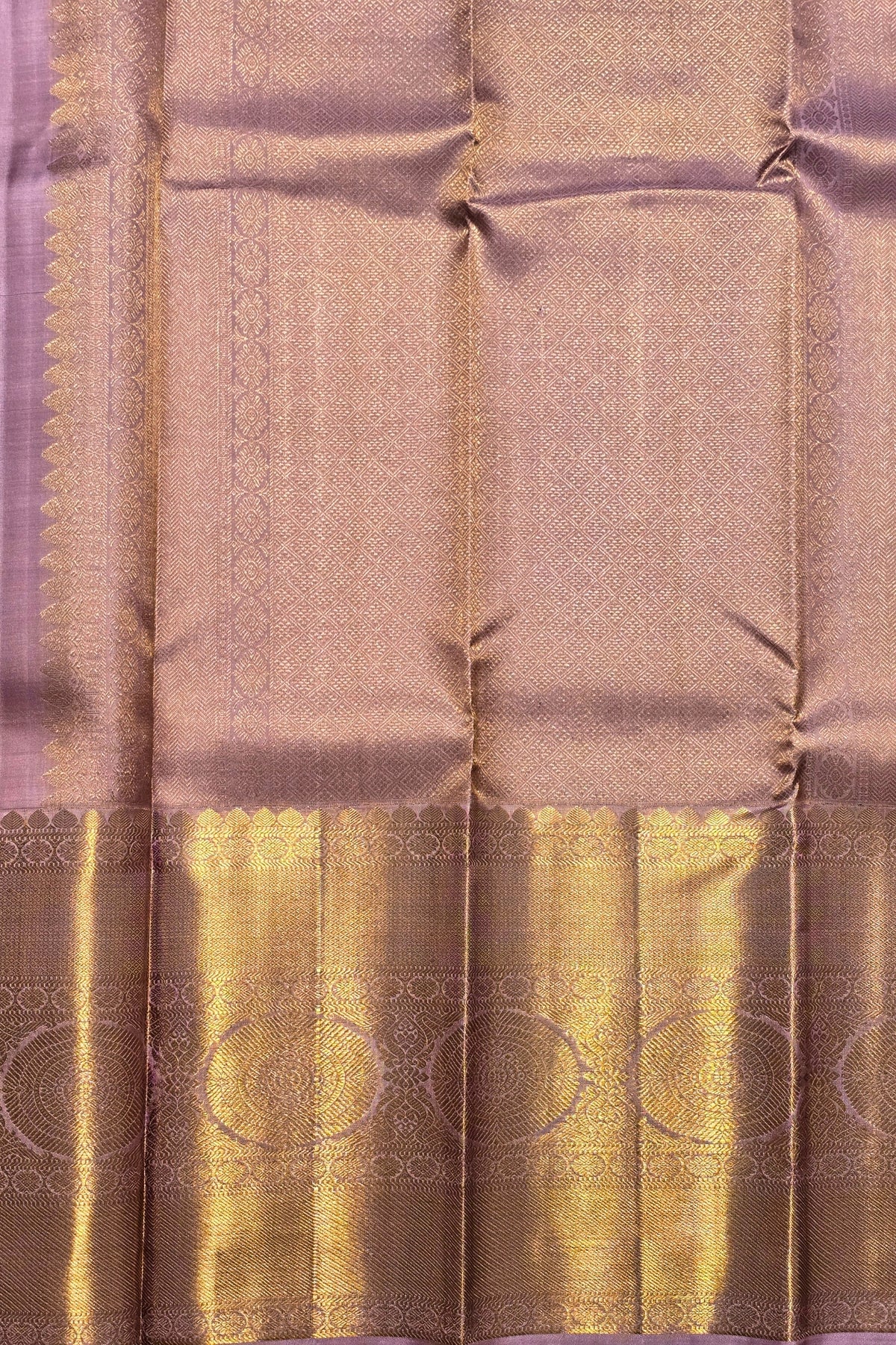 Silk saree with a gold border and intricate patterns