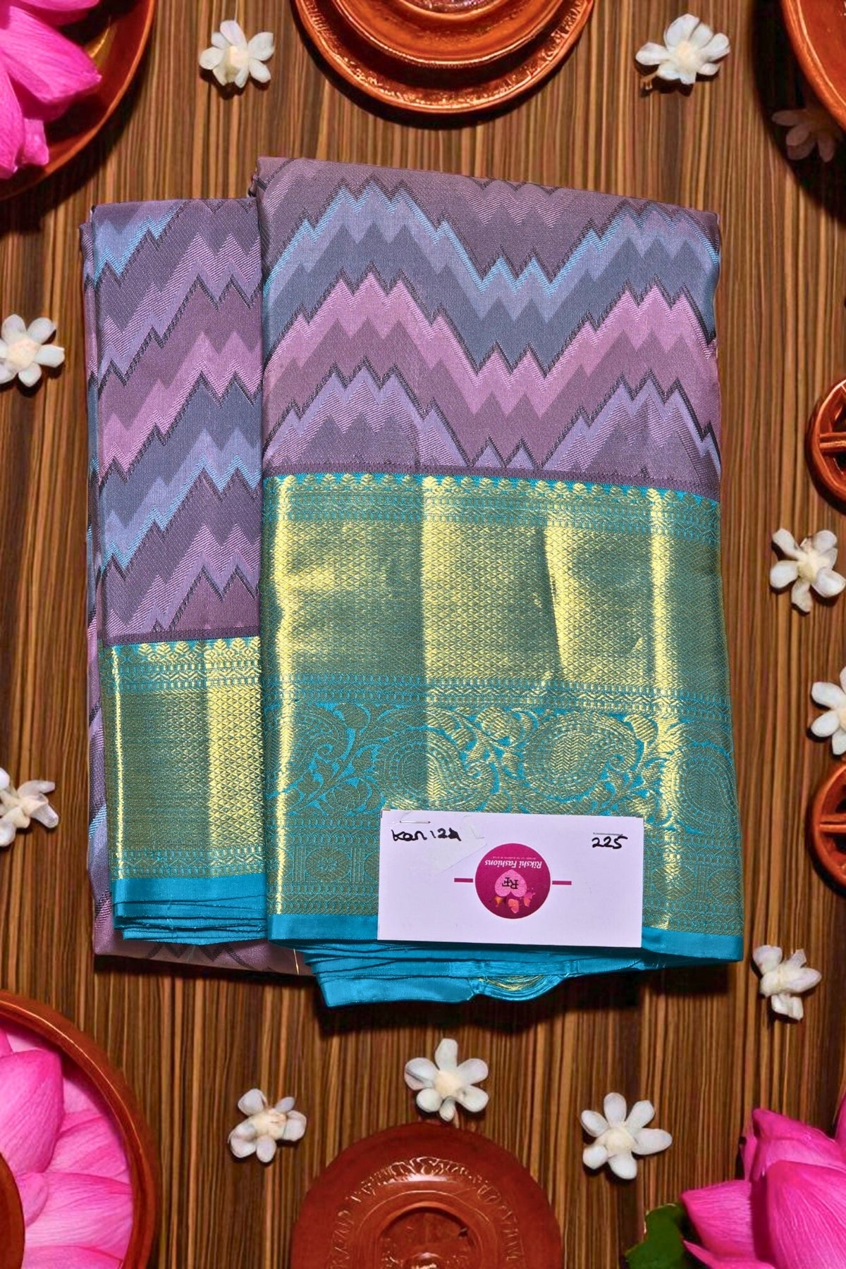 Colorful fabric with a zigzag pattern on a wooden surface with decorative elements.