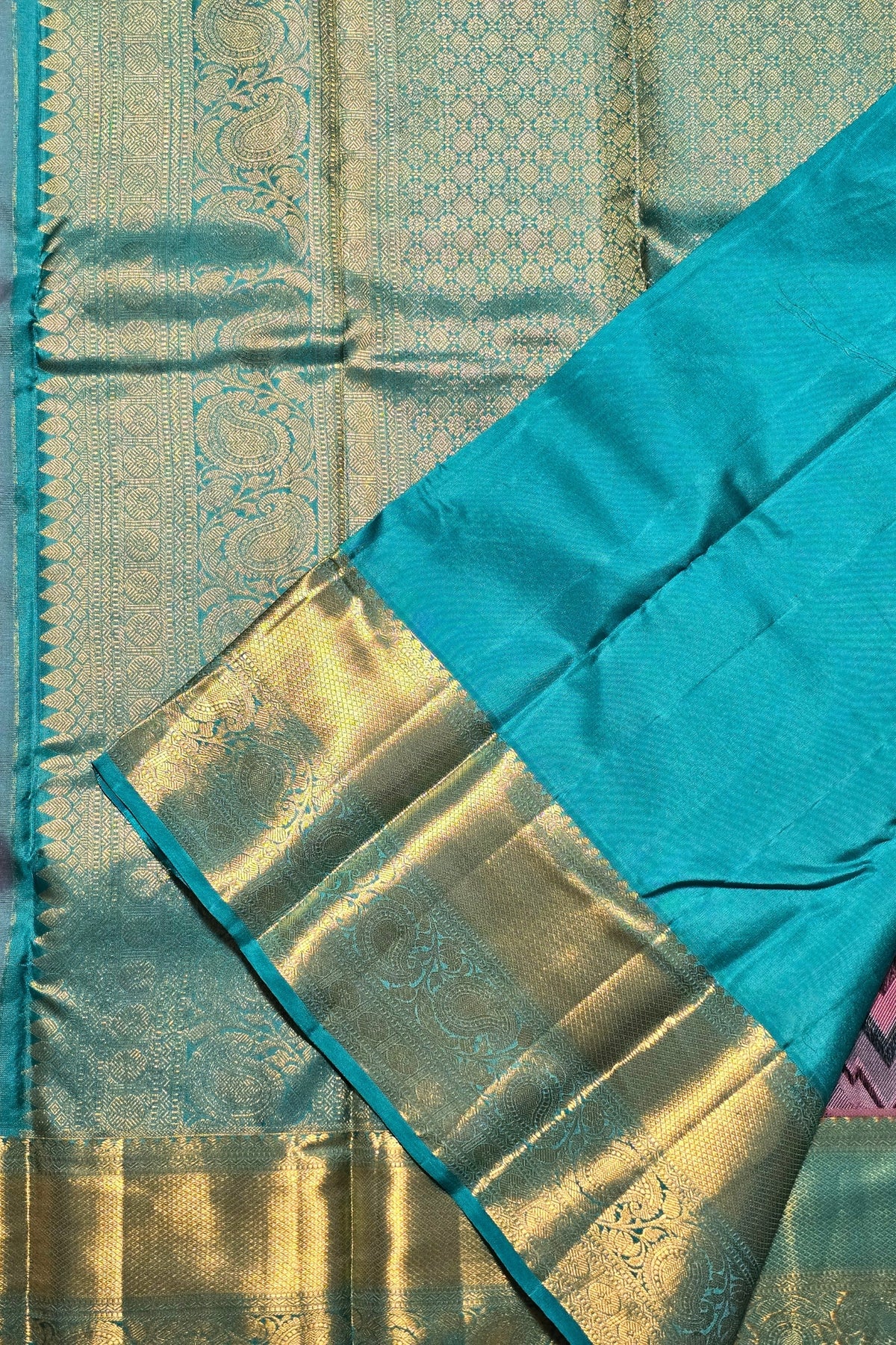 Close-up of a blue fabric with gold border