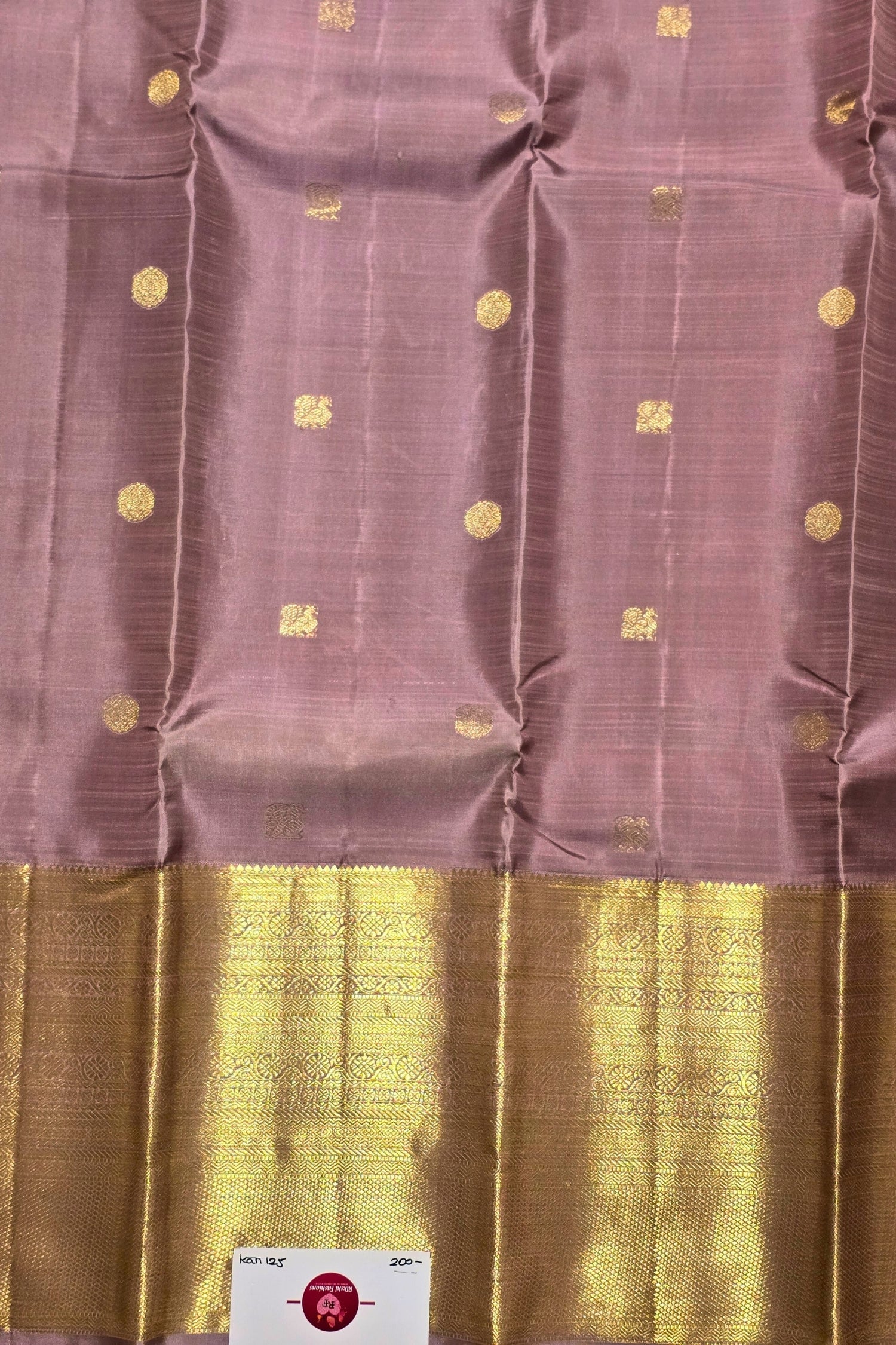 Purple fabric with gold patterns and a gold border