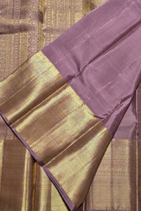 Sari with purple and gold border on a textured fabric background