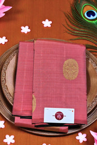 Red saree with gold patterns on a wooden surface with decorative elements