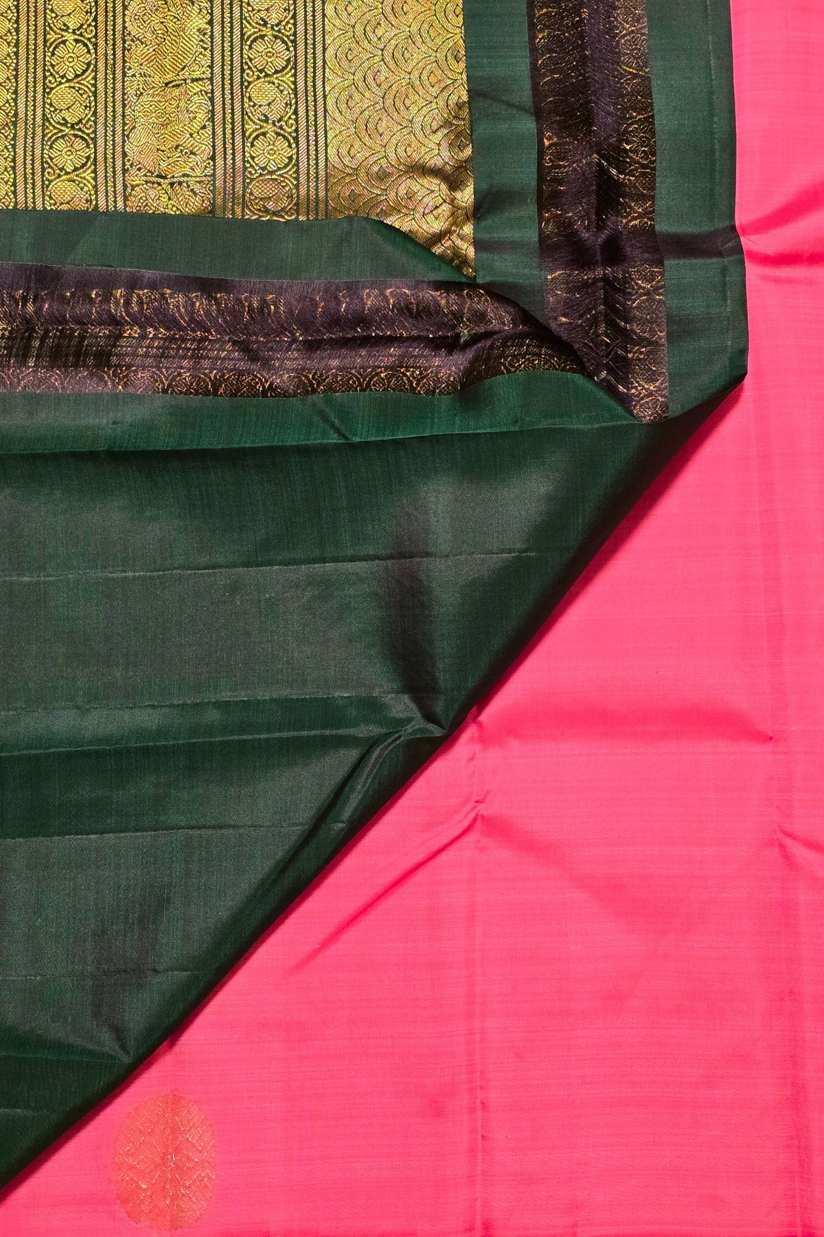 Close-up of a green and pink fabric with intricate patterns