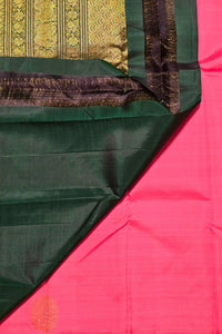 Close-up of a green and pink fabric with intricate patterns