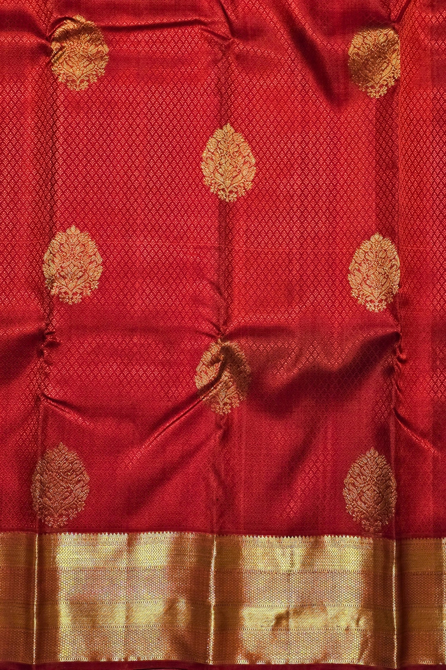 Red fabric with gold floral patterns
