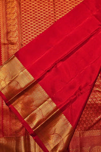 Red saree with gold border and patterns
