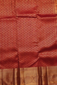 Red fabric with intricate patterns and a gold border