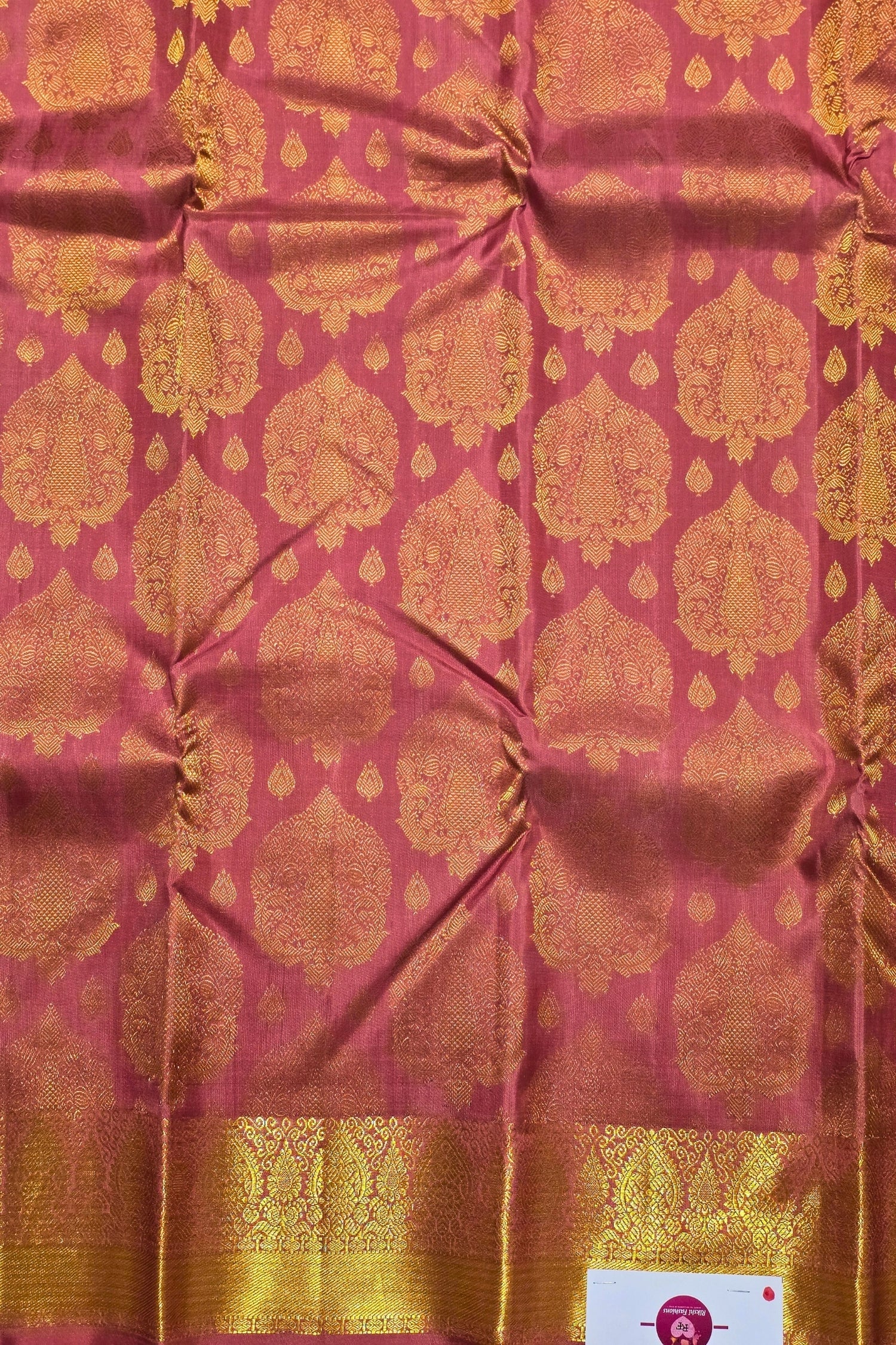 Pink fabric with gold geometric patterns