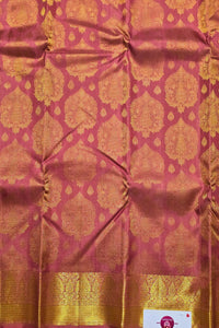 Pink fabric with gold geometric patterns