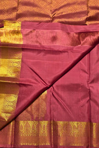 Maroon saree with gold zari border on a plain background