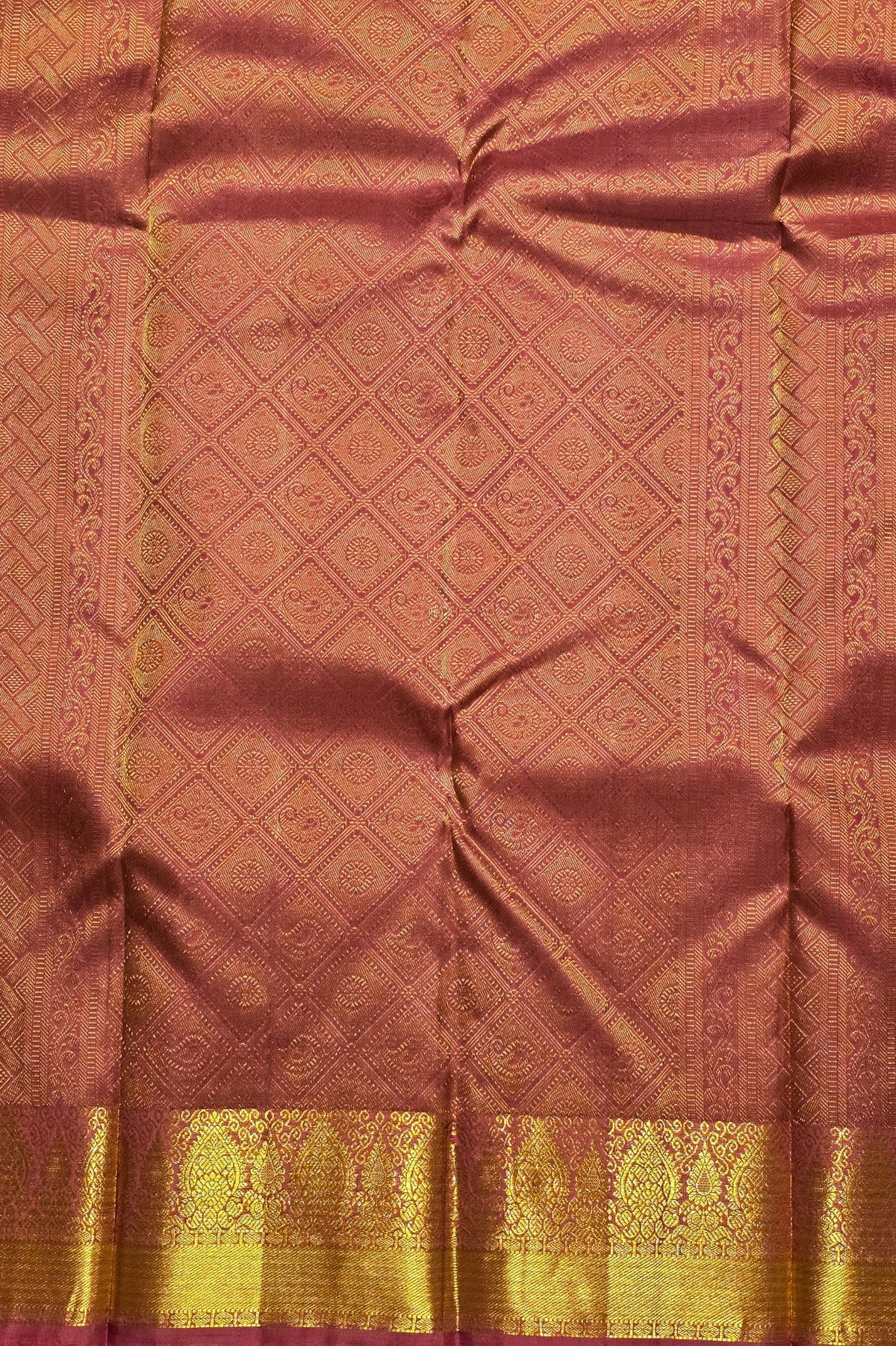 Brown fabric with gold border and intricate patterns