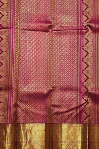 Traditional pink and gold fabric with intricate patterns