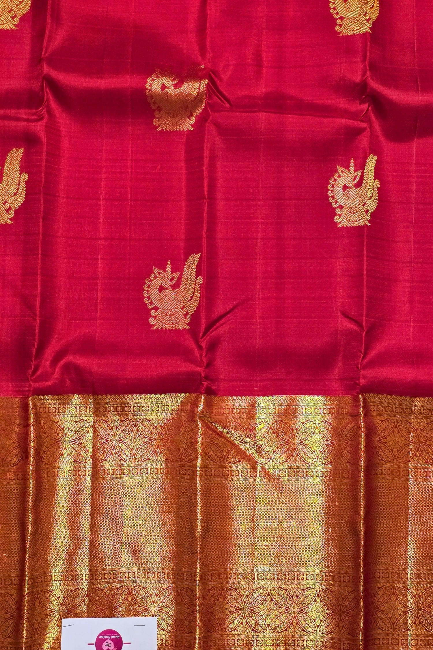Red fabric with gold patterns and a checkered border