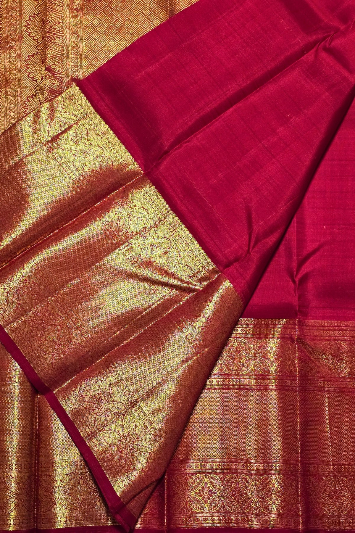 Red and gold traditional fabric with intricate patterns