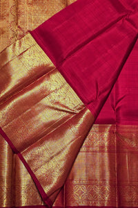 Red and gold traditional fabric with intricate patterns