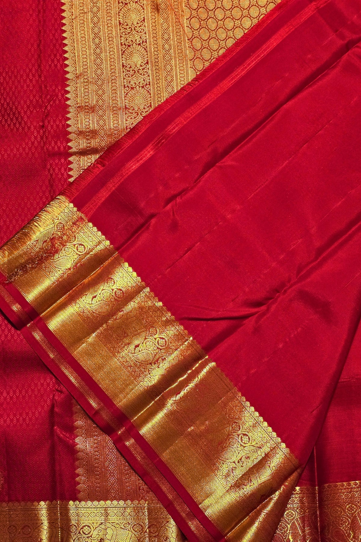 Red saree with gold border and patterns