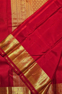 Red saree with gold border and patterns