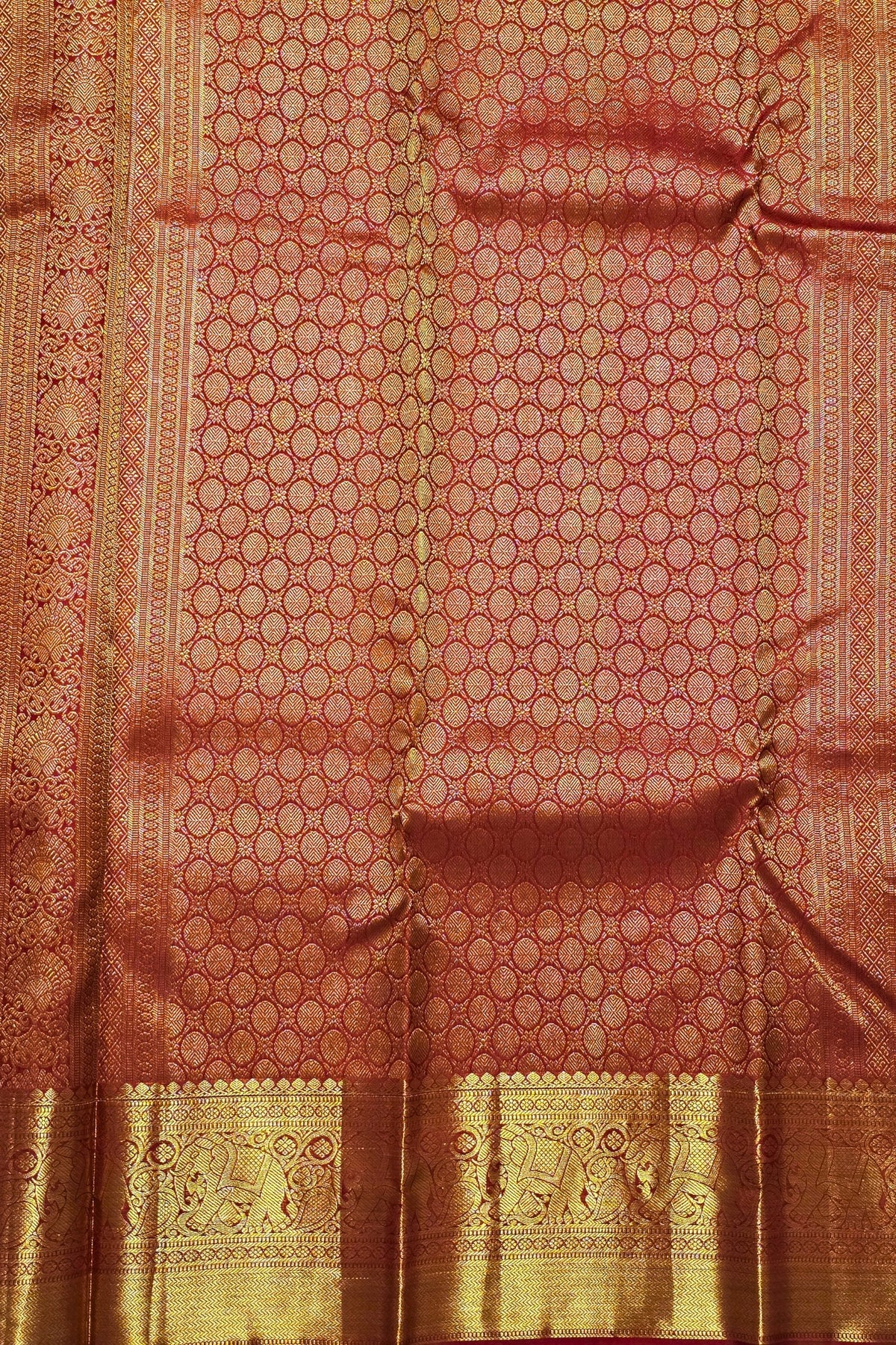 Red and gold traditional fabric with intricate patterns