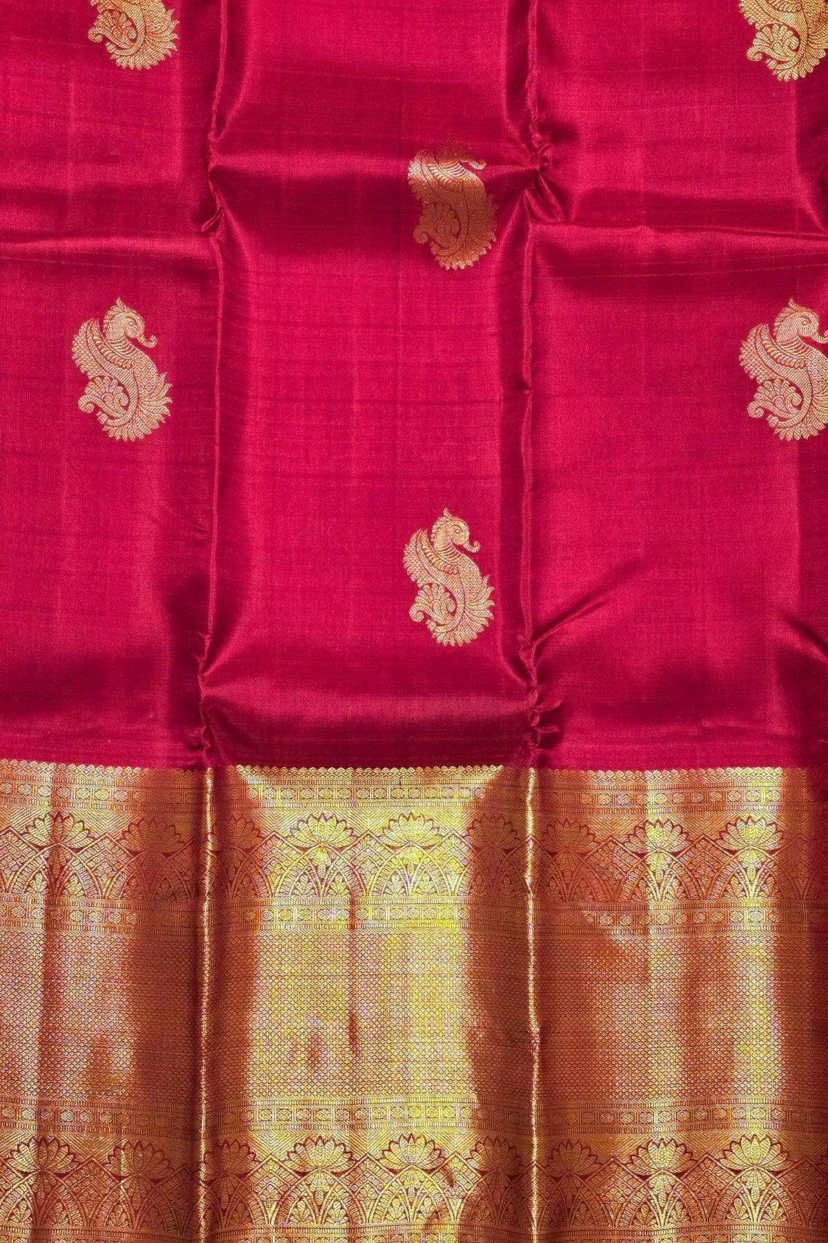 Red fabric with gold patterns and borders