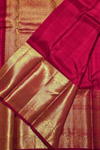Red and gold traditional fabric with intricate patterns