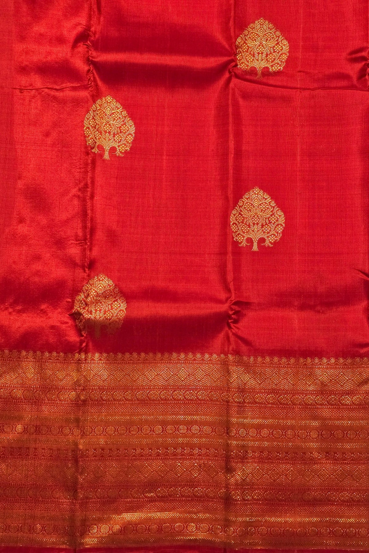 Red fabric with gold tree patterns